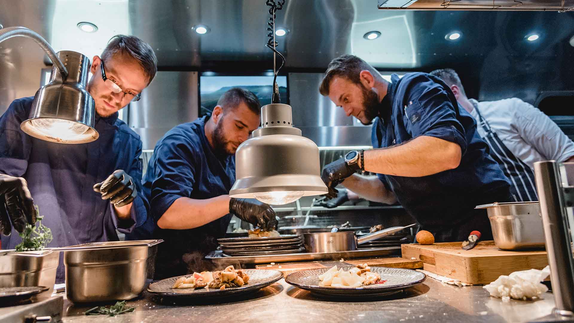 TONI’S EATERY kitchen team plating dishes